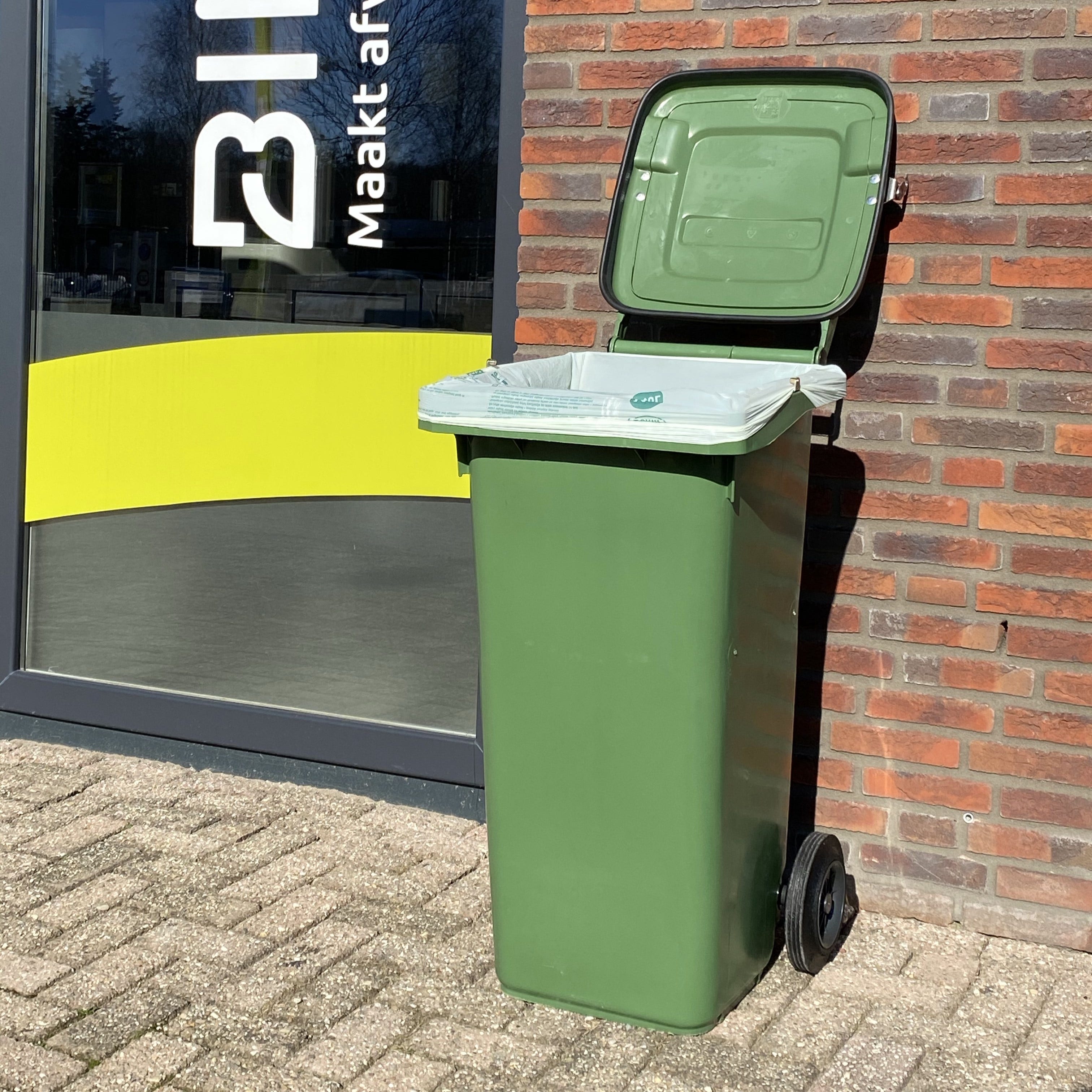 Afvalcontainer bij bedrijf neerzetten